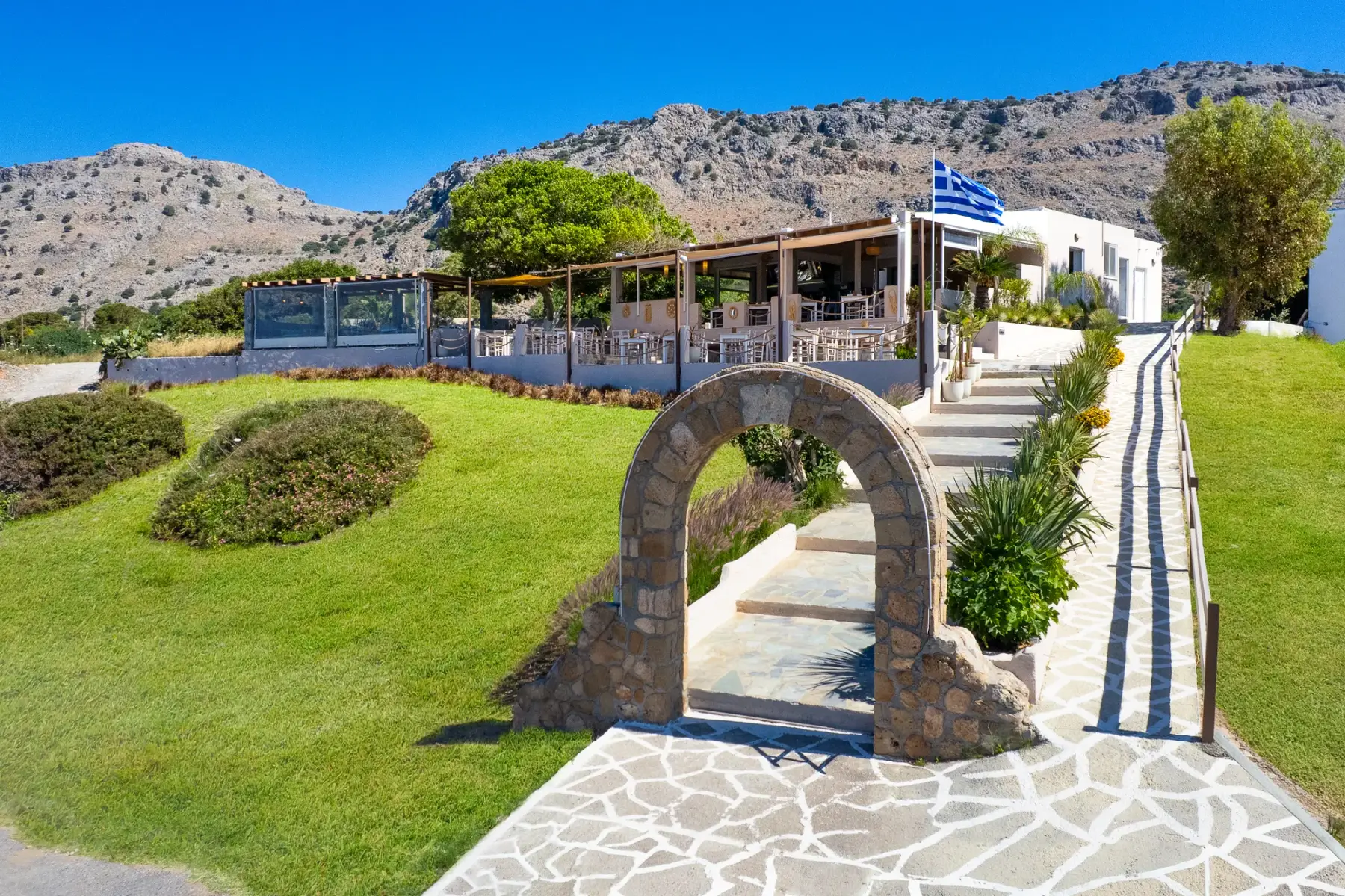 Aerial view of the stone arch, grounds and restaurant at Parea Sea Side